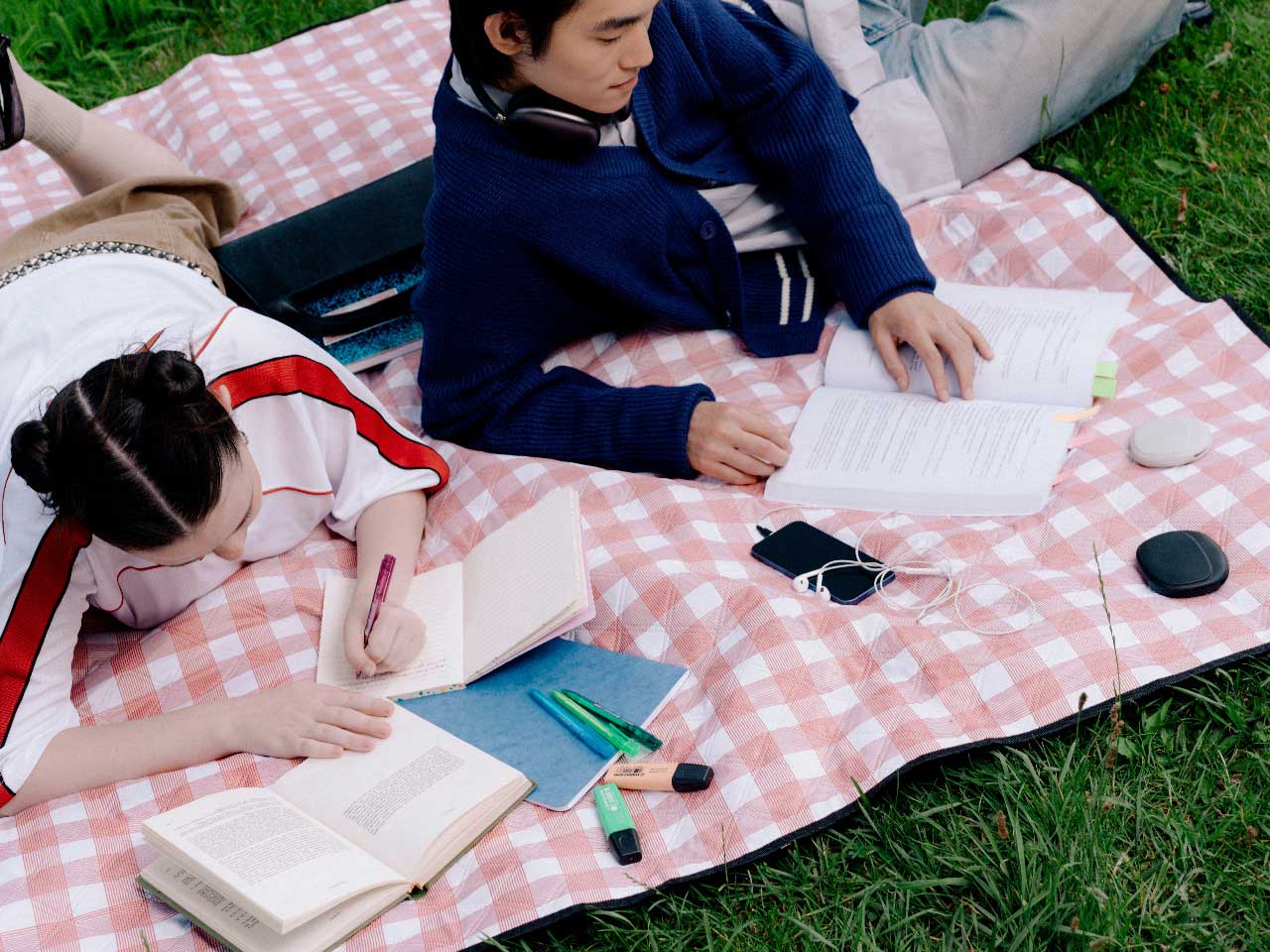 Two Canadian students studying with a phone nearby