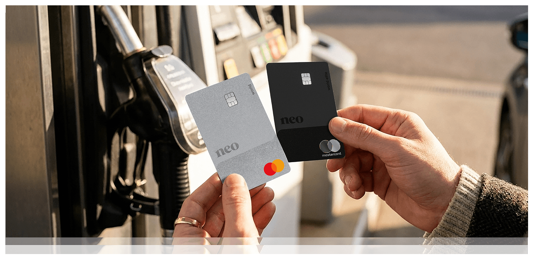 A person holding the Neo World Mastercard and Neo World Elite Mastercard - Gas & Grocery cards, two of the best cash back credit cards in Canada, at the gas pump.