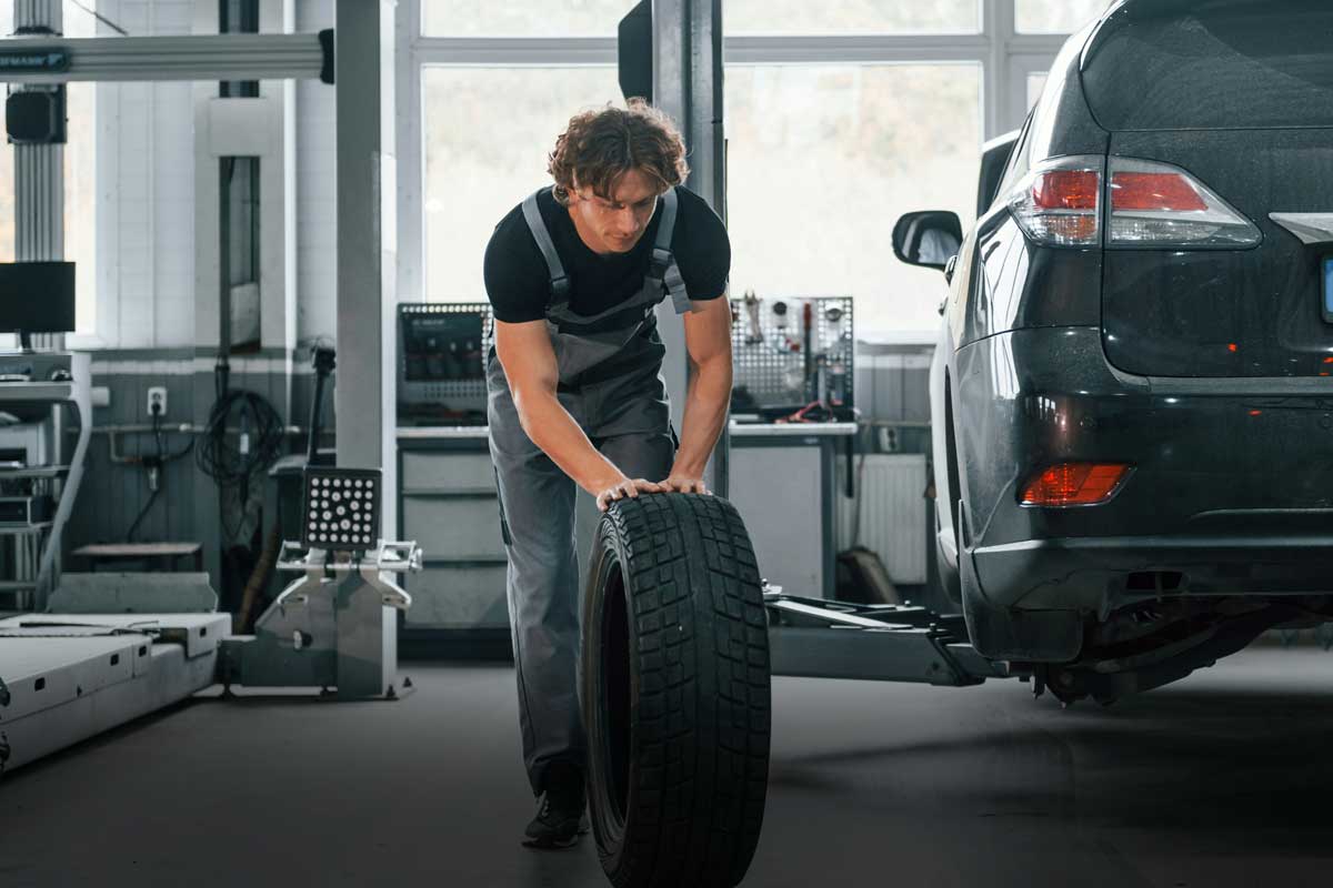 A Canadian mechanic about to put winter tires on a customers car, who got a great deal on the tires.