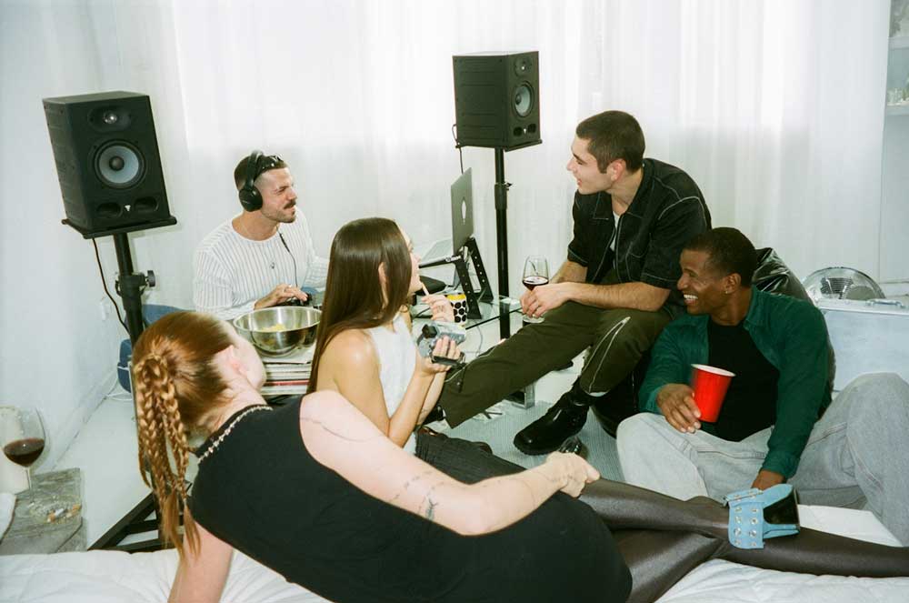 A group of friends spending the evening together in an apartment, after having used a secured credit card as a credit card.