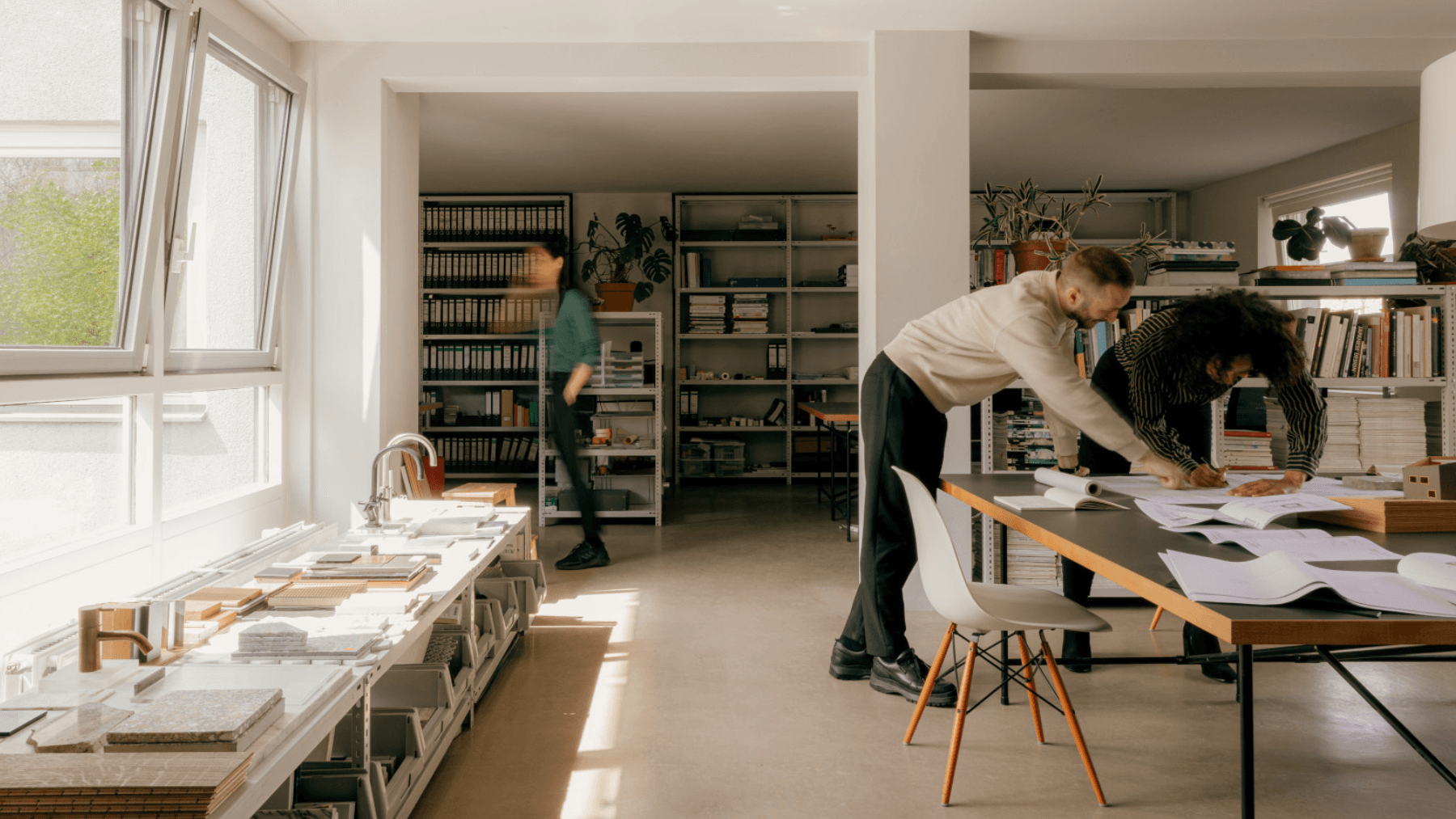 Three people in a shared office, researching payday loan alternatives in Canada