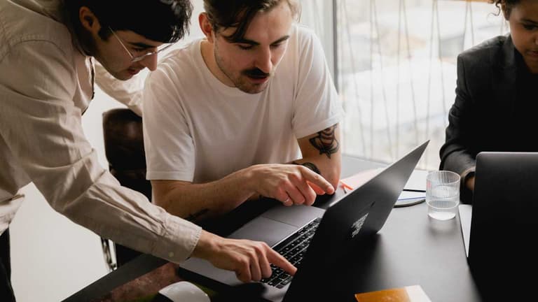 Two Canadian men looking at their income tax prep, discussing the new changes for the 2025 income tax year.
