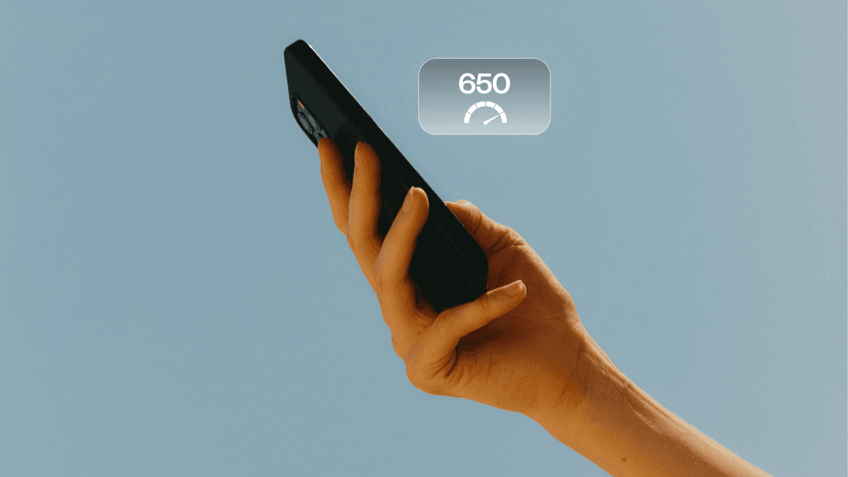 A person on their mobile phone, checking what they can do with a 650 credit score in Canada.